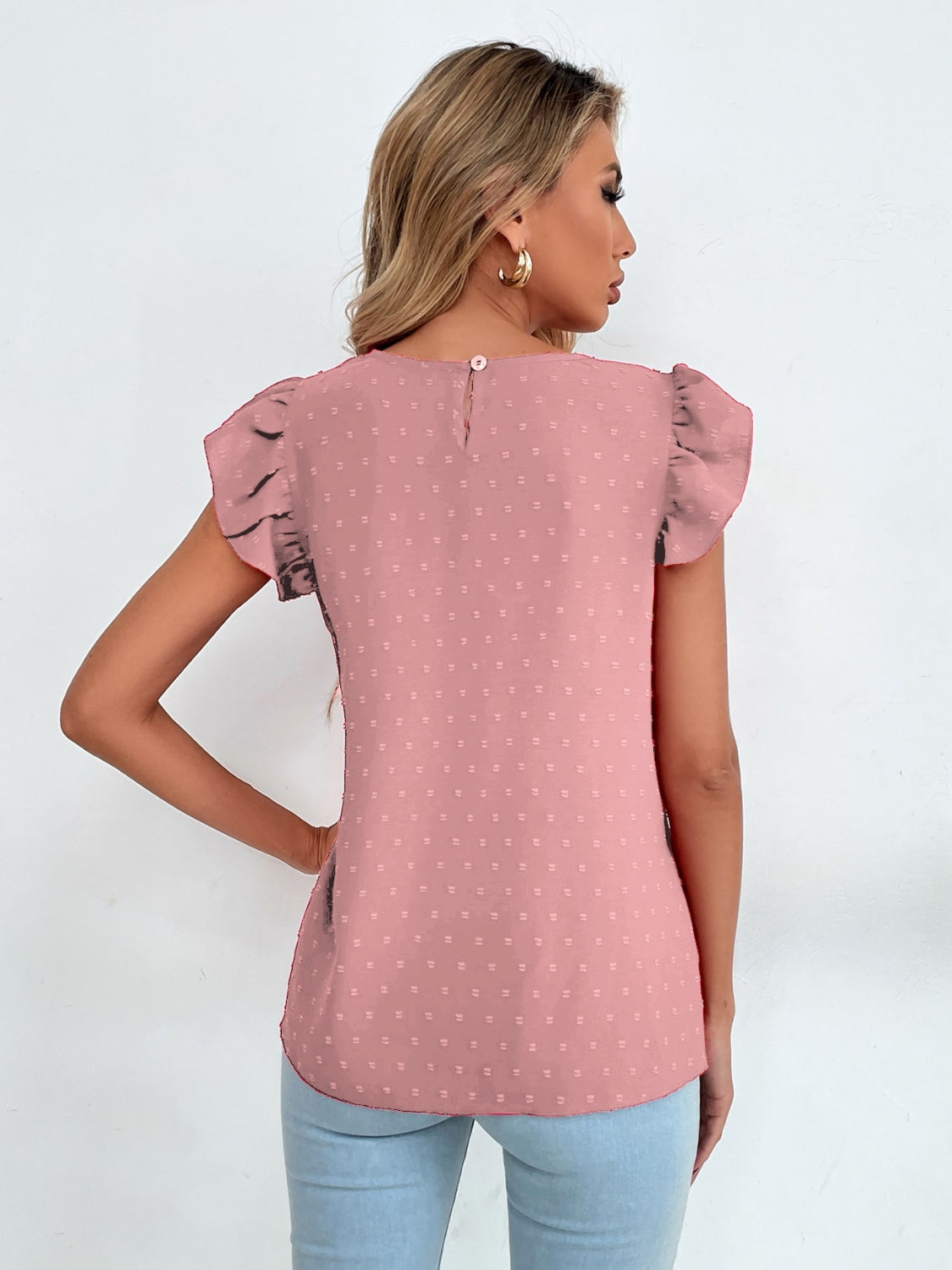 Blush pink dotted swiss keyhole ruffle sleeve blouse with button back closure.