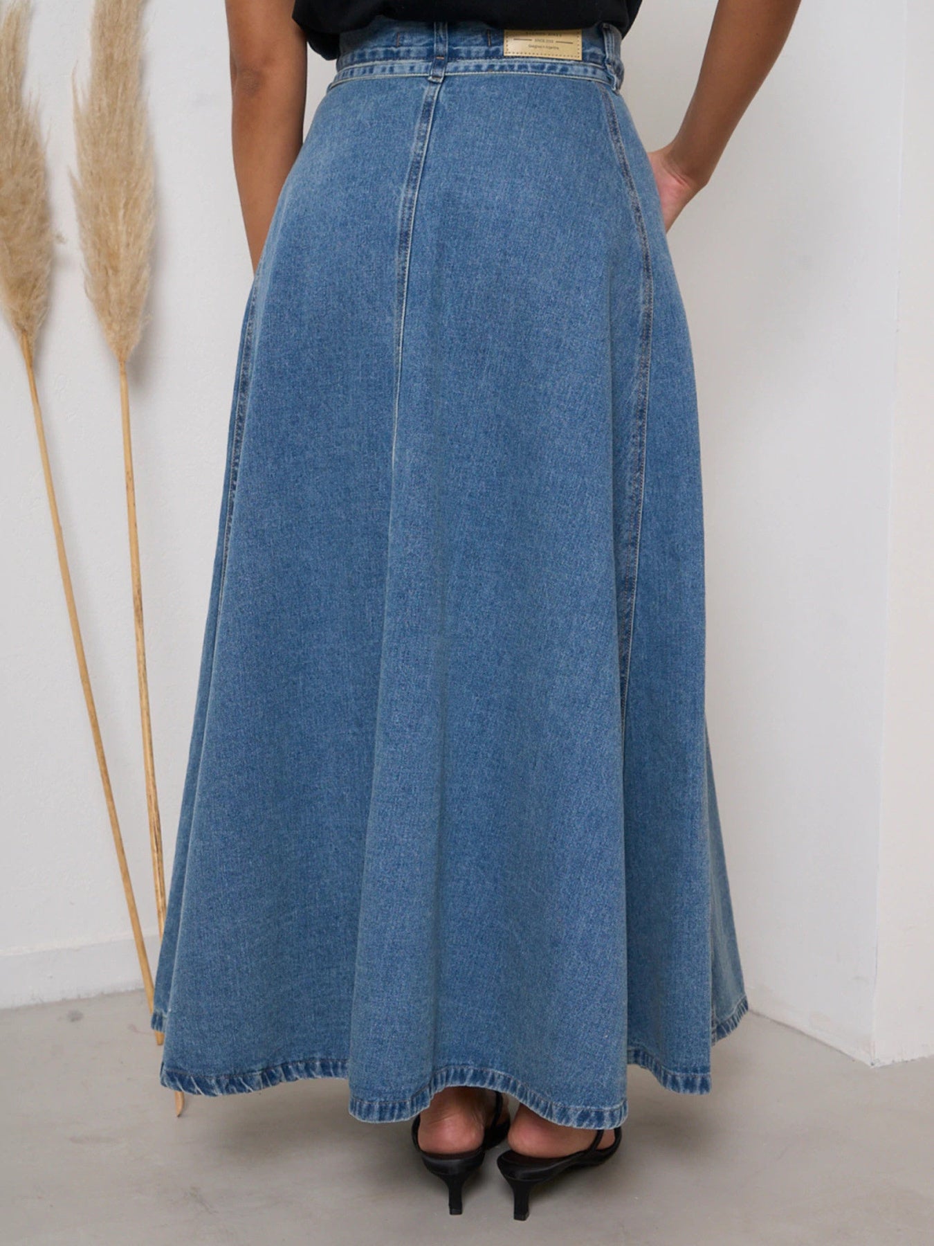 High-waisted A-line denim skirt in Dusty Blue, with a full, flowing cut.