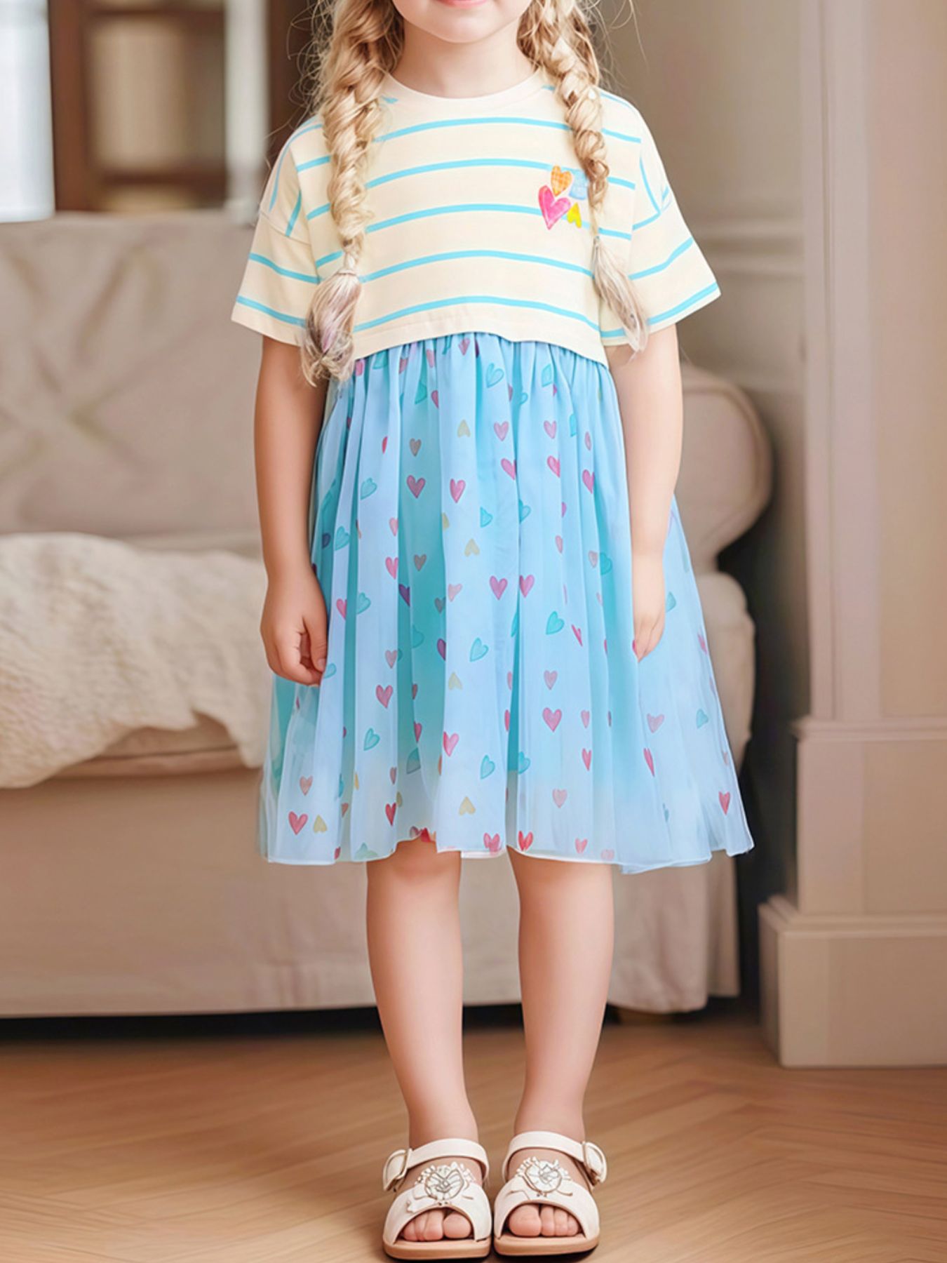 Toddler blue tulle dress with colorful heart print and striped top.