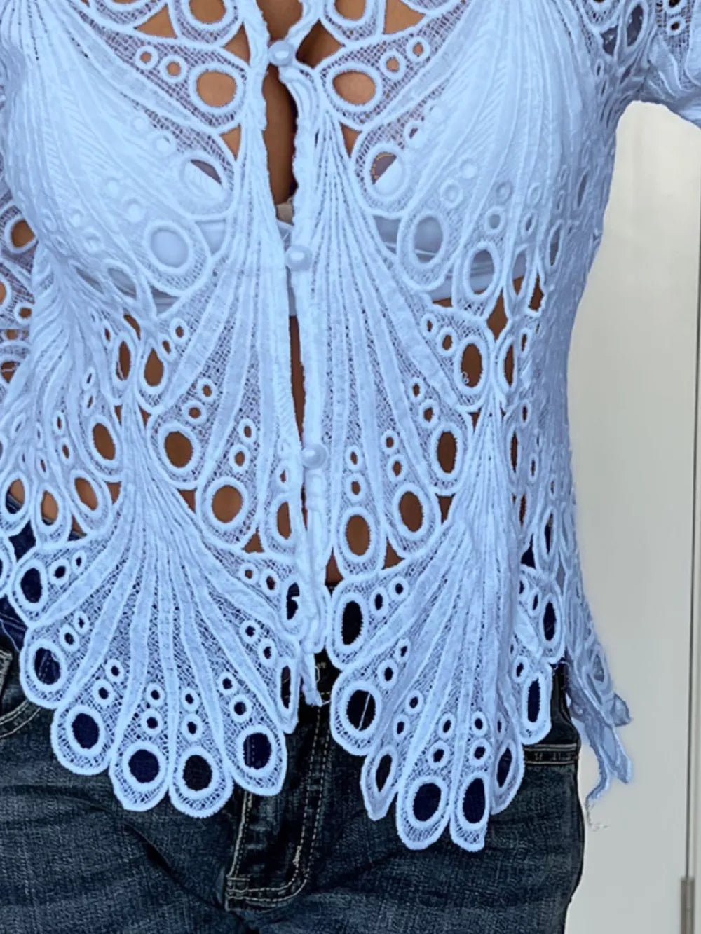 Blue lace button-up blouse with scalloped collar and intricate peacock feather pattern.