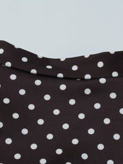 Brown polka dot mini dress with a cut-out detail and a curved neckline.