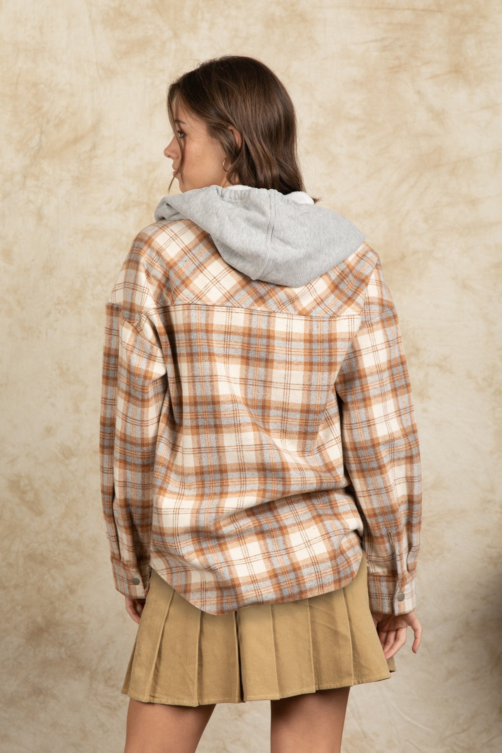 Camel plaid shacket with gray sherpa hood and buttoned cuffs.