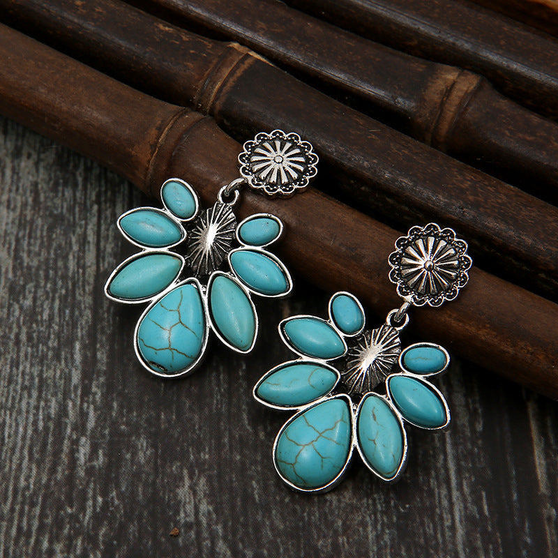 Turquoise petal drop earrings with silver alloy flower detail.