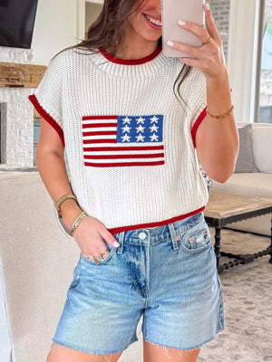 Patriotic knit sweater with American flag design, red trim, and short sleeves.