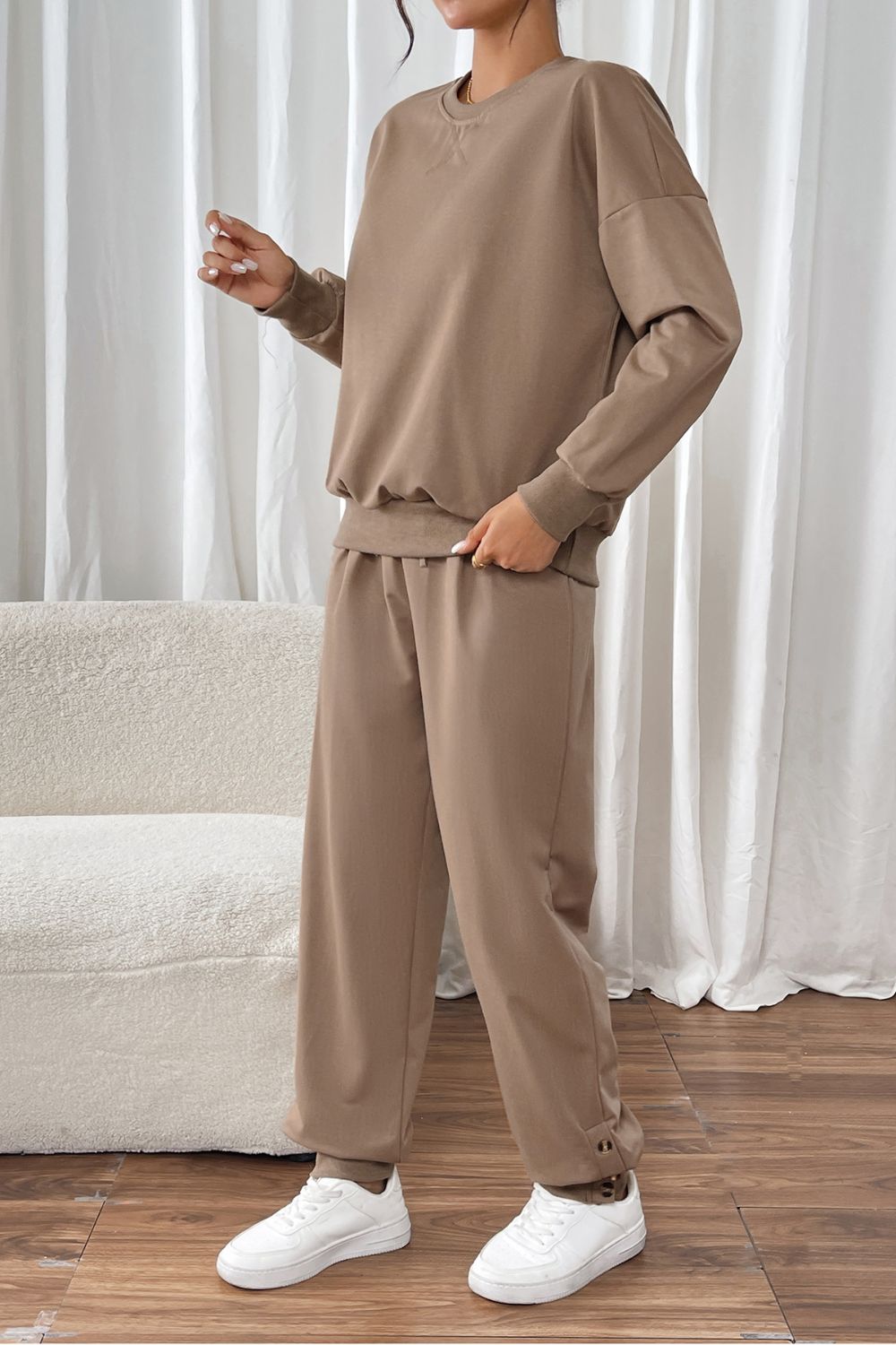 Camel relaxed fit loungewear set with crewneck sweatshirt and drawstring pants.