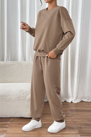 Camel relaxed fit loungewear set with crewneck sweatshirt and drawstring pants.