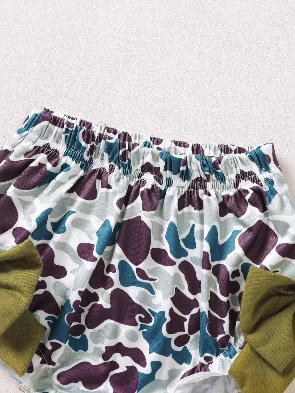 Baby bloomers with camo pattern and olive green bow detail