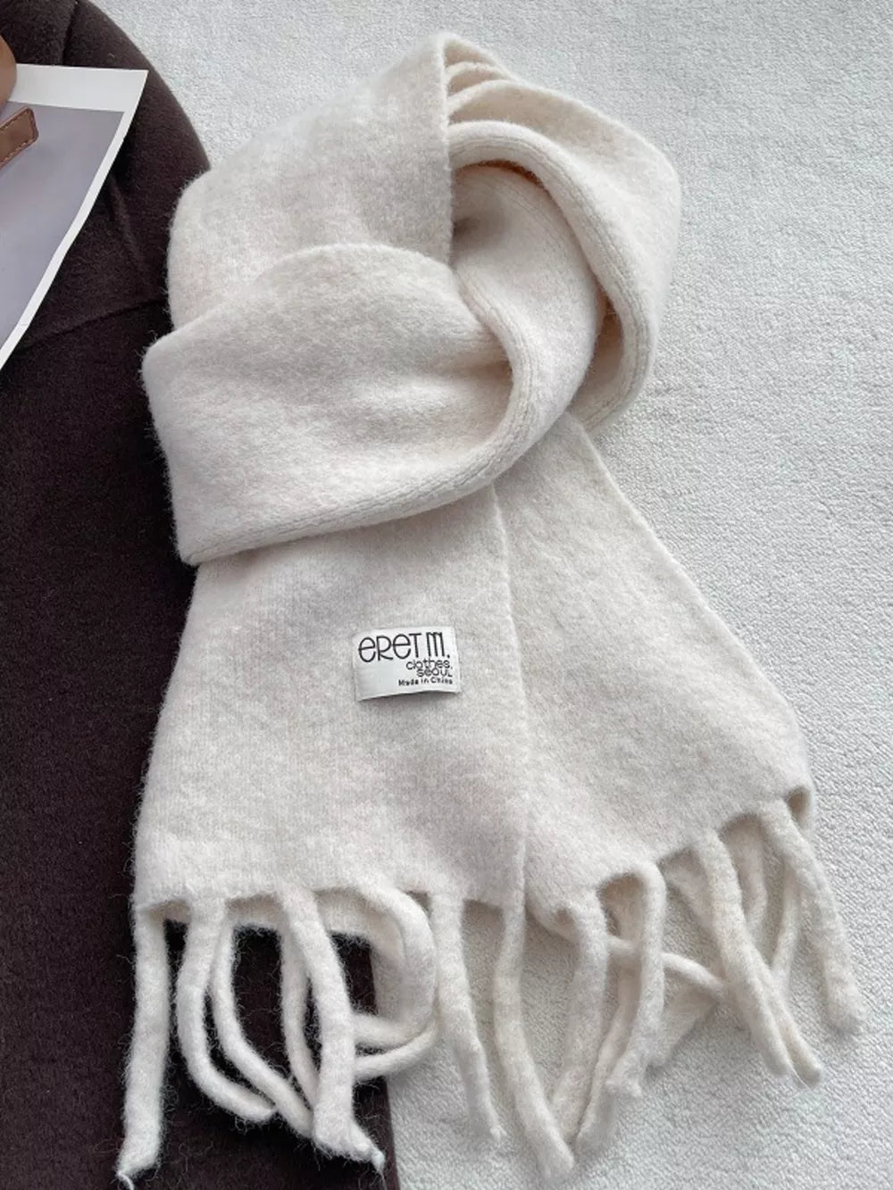 Plush fringe scarf in Ivory White with a soft, cozy texture and a solid design.