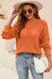 Orange open-knit crewneck sweater with subtle texture and long sleeves.