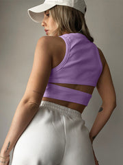 Lavender ribbed crop top with cutout detail and racerback, paired with white sweatpants.