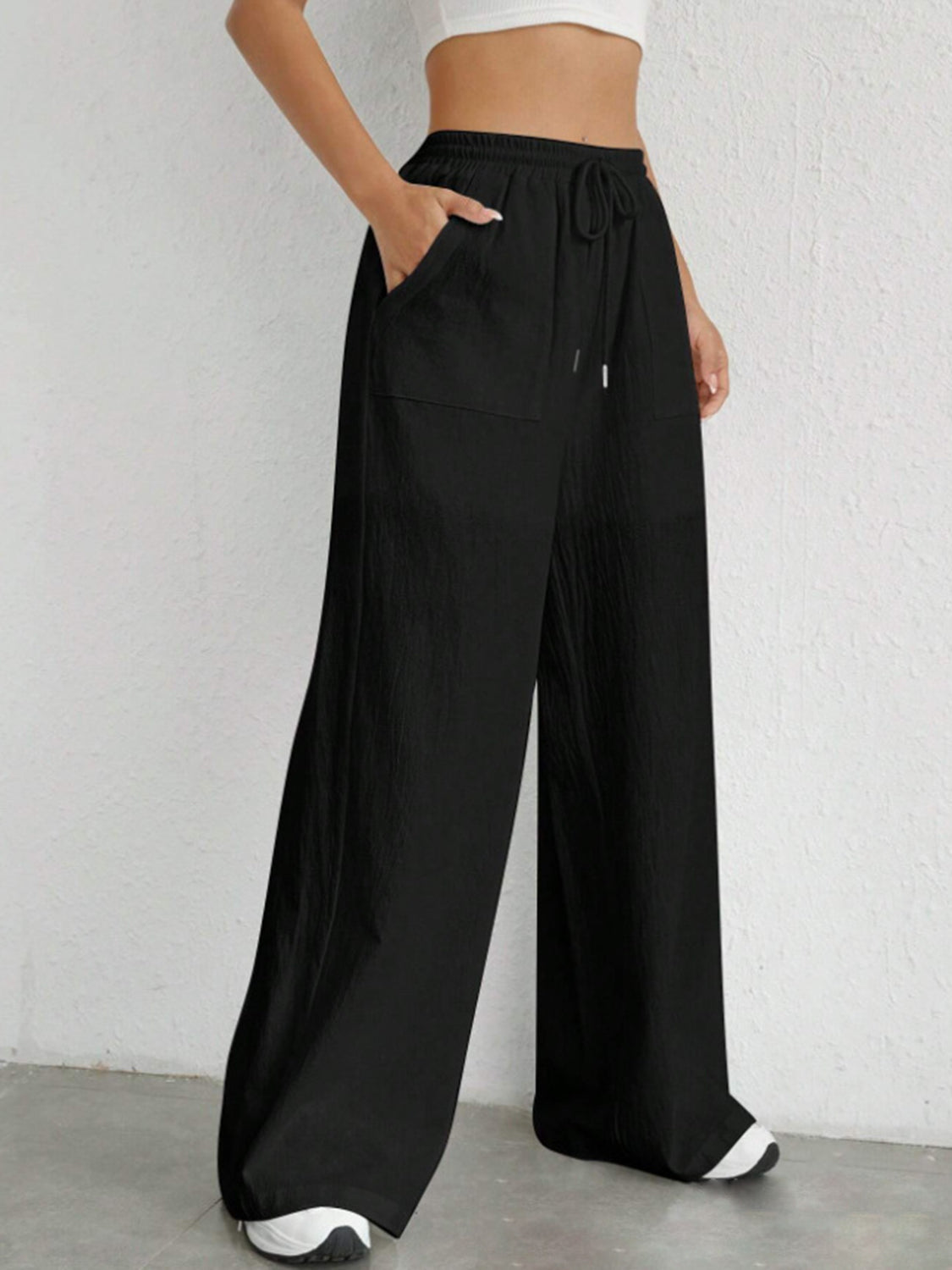 Black linen wide-leg drawstring trousers with pockets