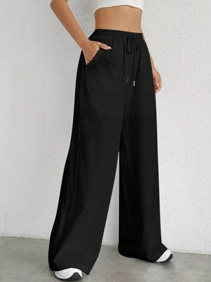 Black linen wide-leg drawstring trousers with pockets