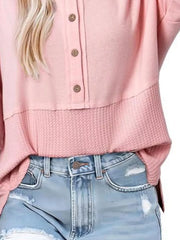 Pink waffle-knit t-shirt with button detail and contrast textured hem.