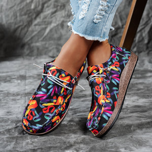 Printed casual slip-on loafers with abstract brushstroke pattern and white laces.