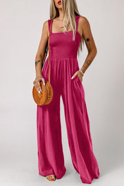 Sway Square Smocked Jumpsuit in Deep Rose with wide legs and pockets.