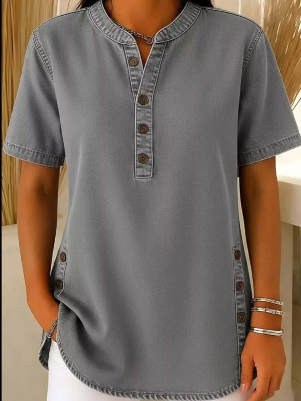 Grey denim-inspired short sleeve button blouse with band collar and side button detail.