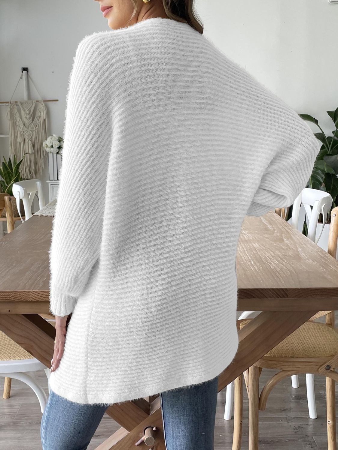 White ribbed knit dolman sleeve cardigan with a relaxed fit and fuzzy texture.