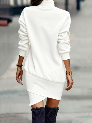 White turtleneck mini dress with asymmetrical hem and long sleeves.