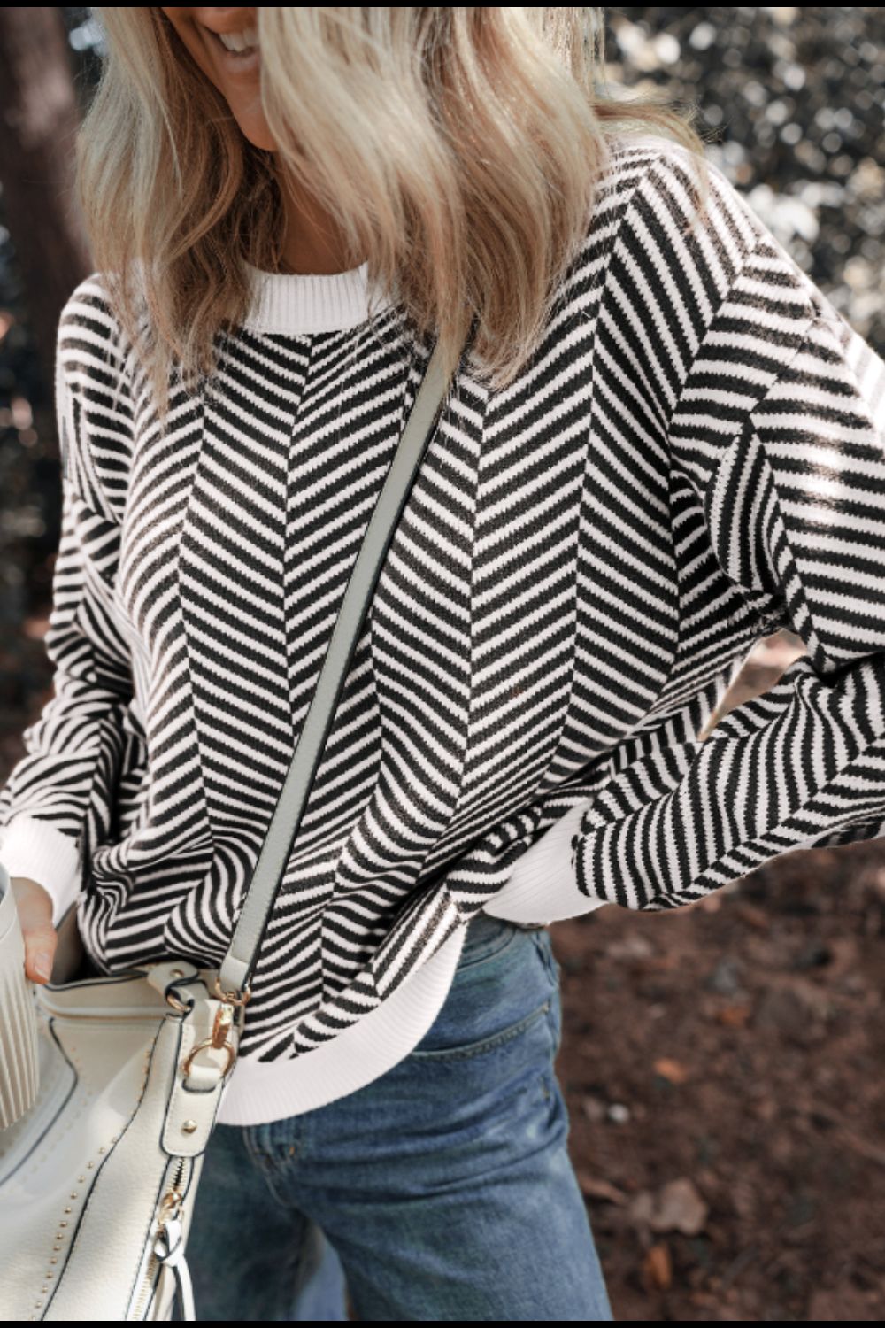 Chevron knit crewneck sweater in black and white with white cuffs and hem.