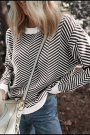 Chevron knit crewneck sweater in black and white with white cuffs and hem.