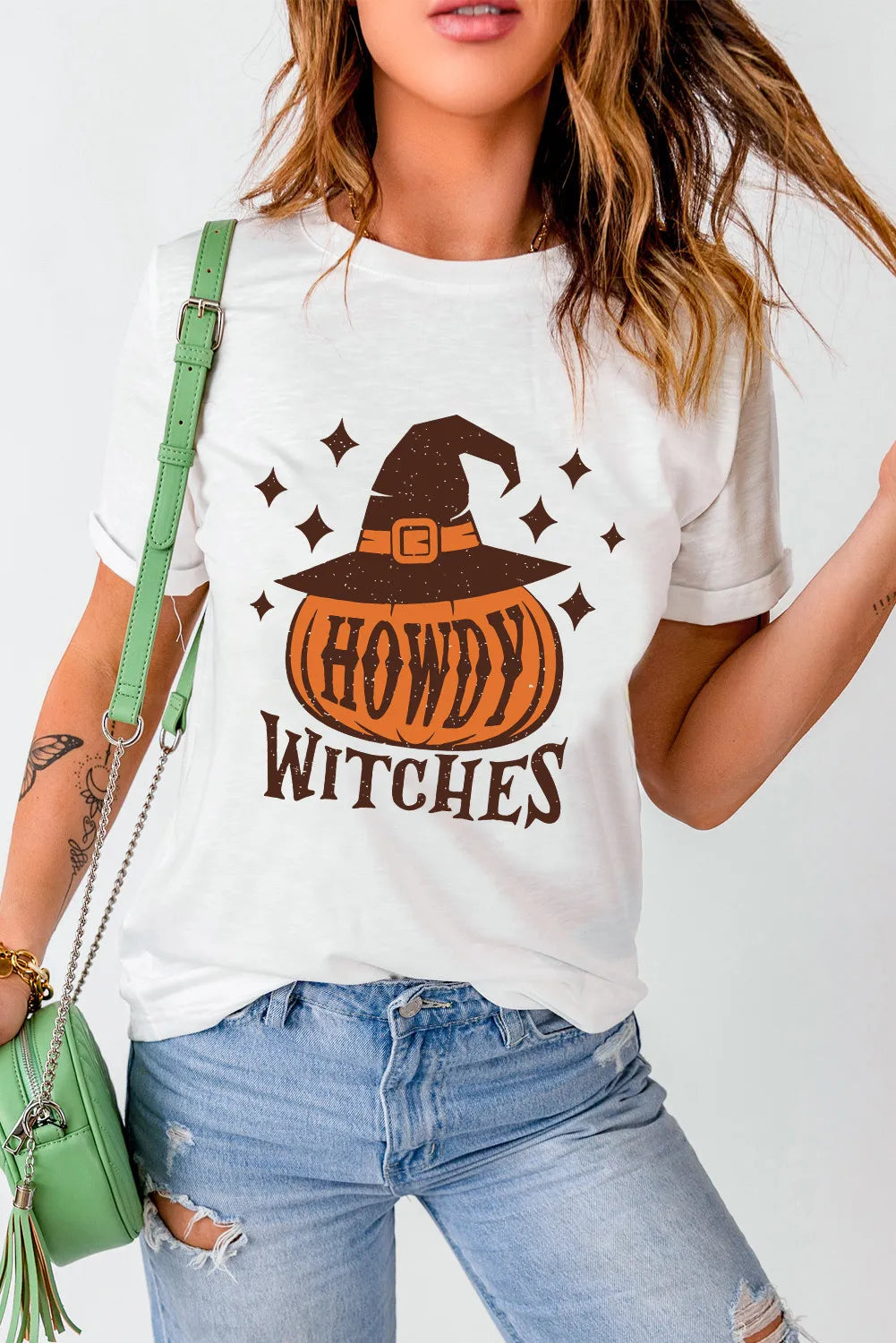 White cotton t-shirt with witch hat pumpkin graphic and "Howdy Witches" text.