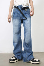 Baggy denim jeans in distressed wash medium blue with a black belt.