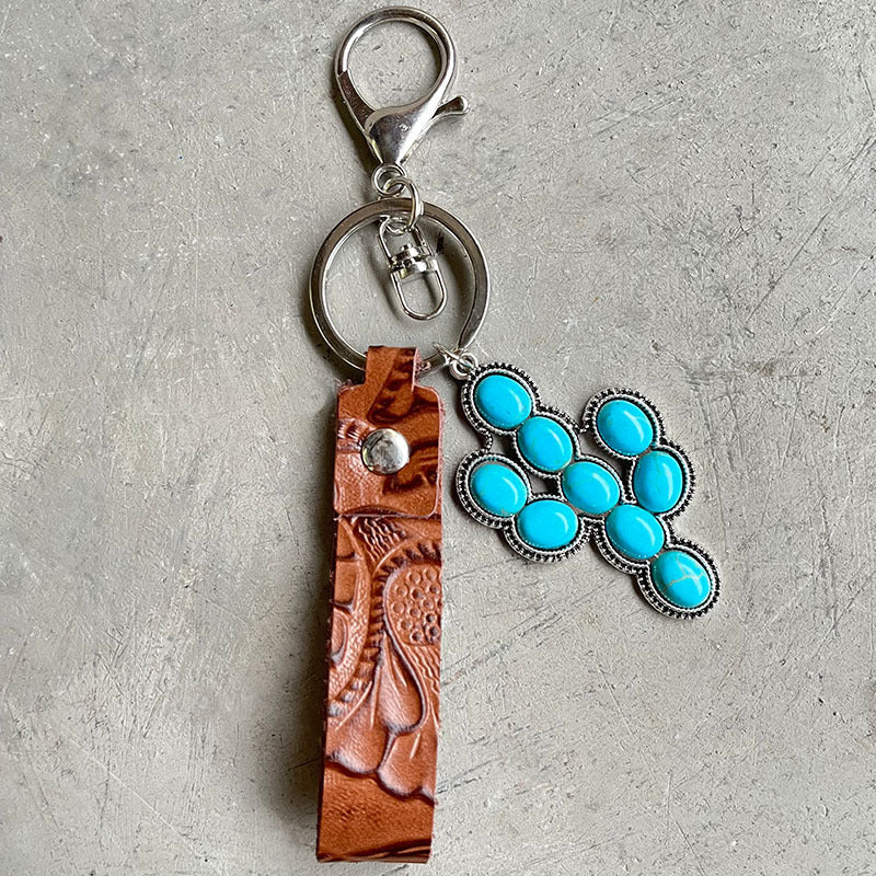 Tooled leather keychain with turquoise stones and silver hardware.