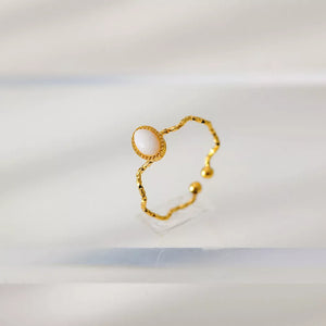 Wavy gold-plated ring with oval cream natural stone and textured band