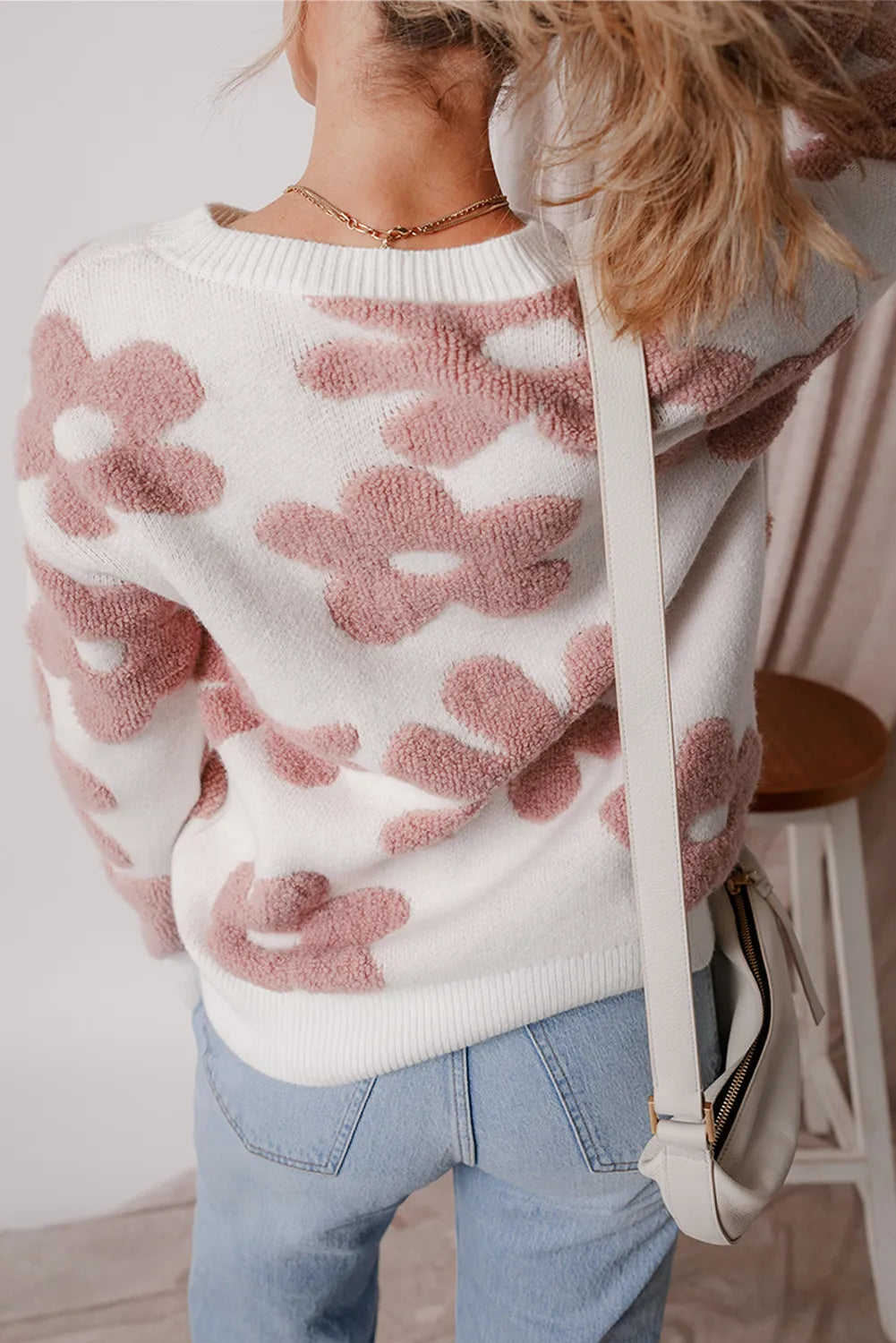 Textured floral knit pullover sweater in white with pink blooms, crewneck, long sleeves.