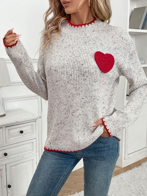Light gray ribbed knit sweater with red heart appliqué and trim.