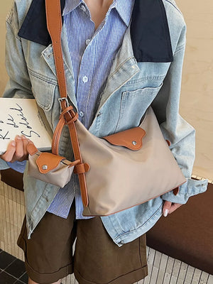 Khaki canvas hobo bag with coin purse and brown leather trim.