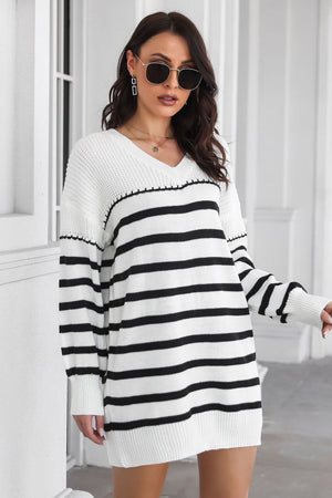 White and black striped knit mini dress with V-neck and long sleeves.