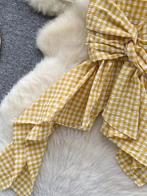 Yellow gingham cami top with twisted knot detail and asymmetrical hem