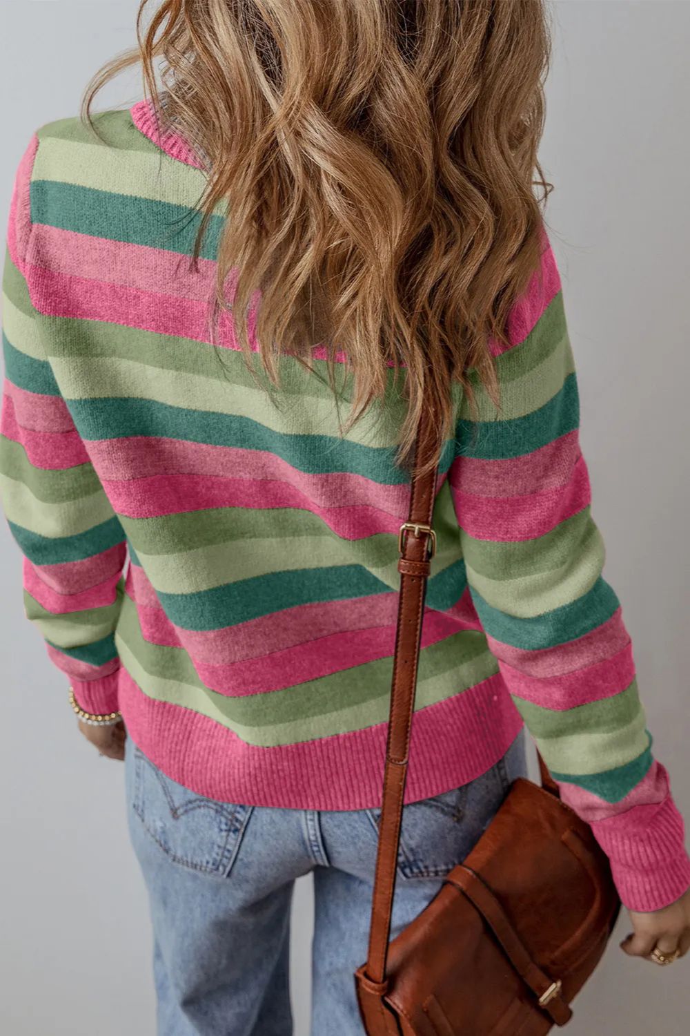 Crewneck knit sweater with horizontal pink and green stripes.