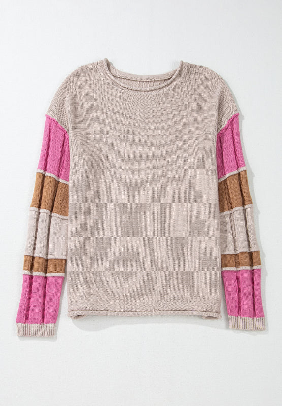 Beige knit sweater with colorblock striped sleeves in pink and brown.