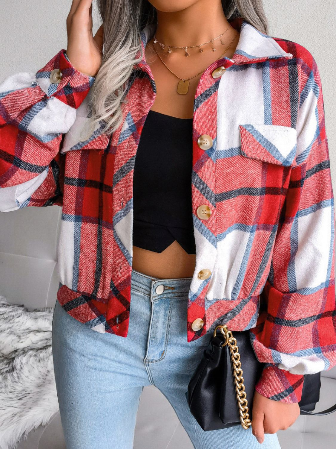 Boxy red plaid shacket with gathered hem and buttoned pockets.