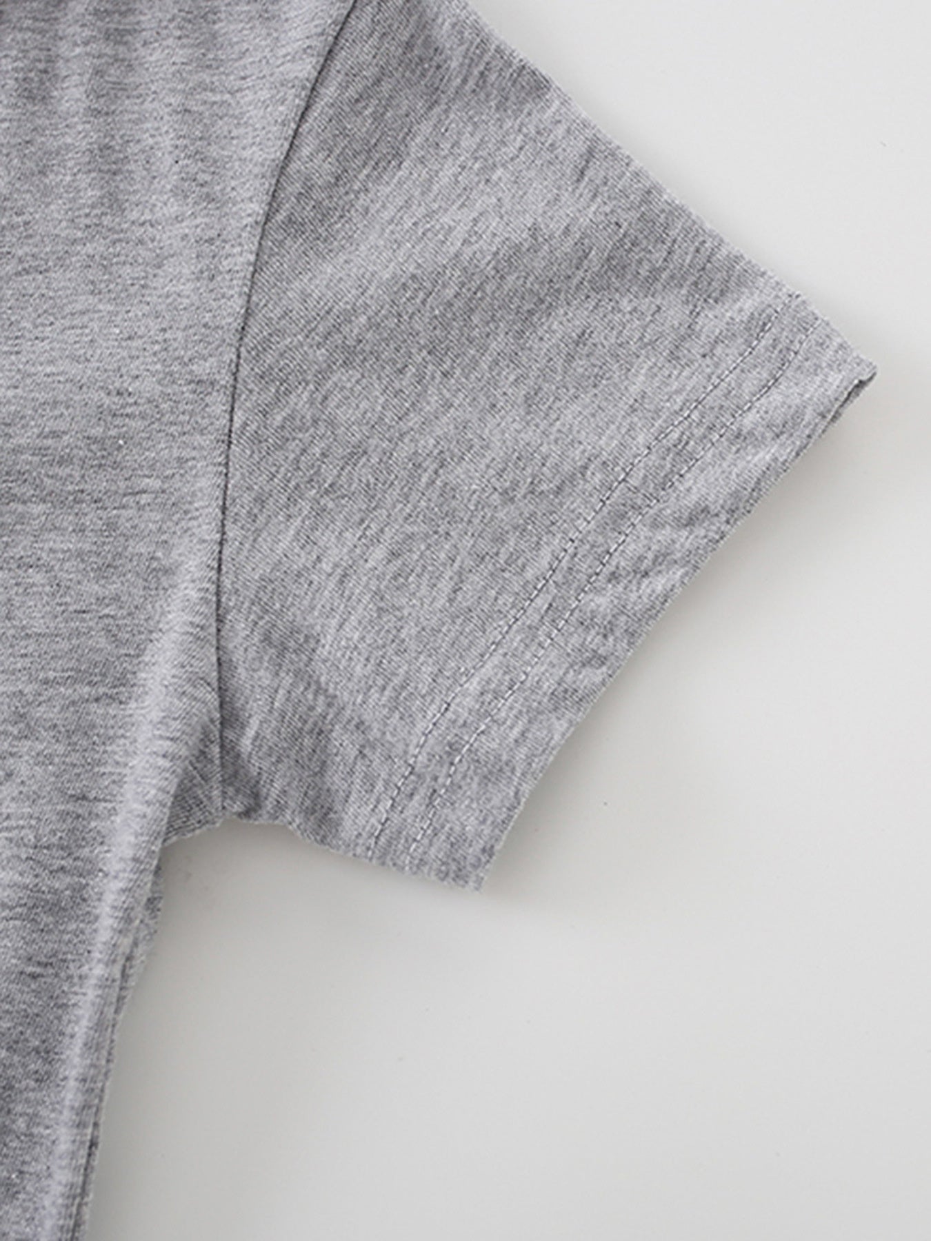 Grey cotton t-shirt with short sleeves and double-stitched hem detail.
