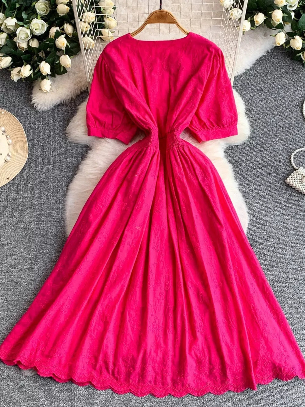 Pink lace-embellished A-line midi dress with puff sleeves and scalloped hem.