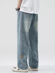 Men's blue wide-leg jeans with drawstring and patch detail