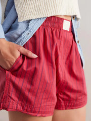 Scarlet boxer shorts with navy pinstripes and elastic waistband.