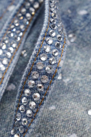 Medium wash denim jeans with ombré crystal embellishments on the seams.
