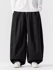 Black relaxed fit drawstring sweatpants with a baggy cut and wide legs.