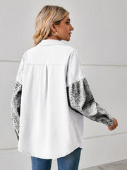 White denim overshirt with leopard print sleeves and buttoned cuffs.