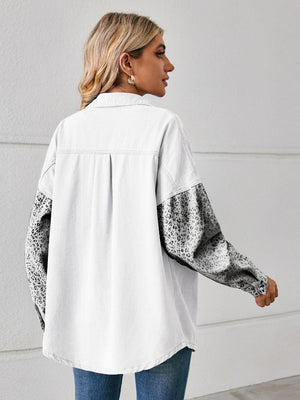 White denim overshirt with leopard print sleeves and buttoned cuffs.