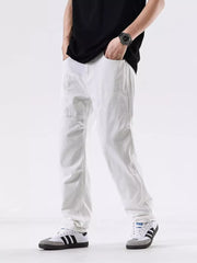 Men's white cotton jeans with a relaxed fit and pocketed design.