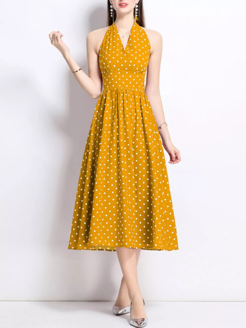 Yellow polka dot halter midi dress with a V-neck and flared skirt.