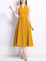 Yellow polka dot halter midi dress with a V-neck and flared skirt.