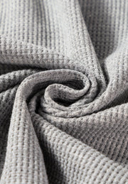Light gray waffle knit cardigan detail showing texture and fabric.
