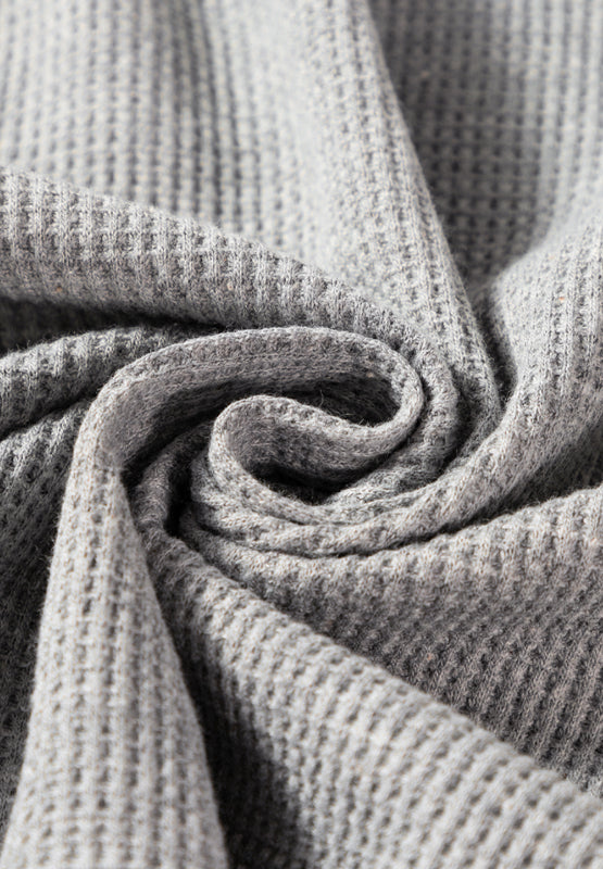 Light gray waffle knit cardigan detail showing texture and fabric.