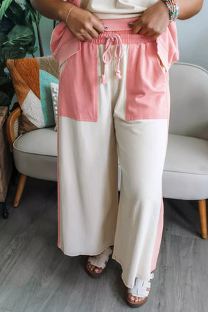Chic color block cotton lounge pants in cream and pink with drawstring waist and wide legs.